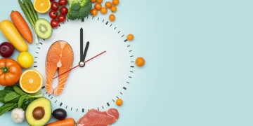 Intermittent fasting concept with clock and healthy food