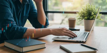 Person researching mental health insurance benefits on a laptop for financial savings in 2025